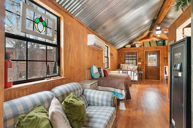 a bed sitting in a bedroom next to a window