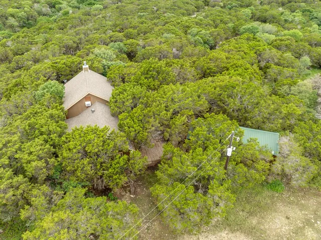 a aerial view of a house with a yard and garage
