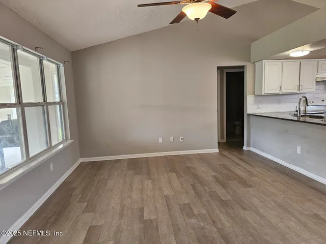 a kitchen with kitchen island granite countertop a sink a counter top space and cabinets