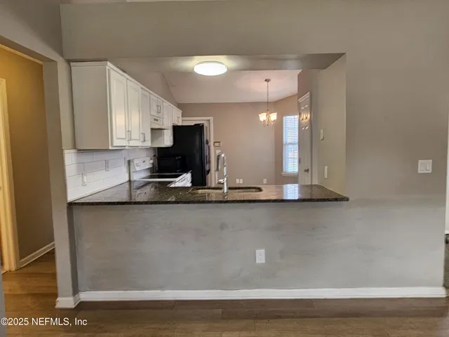 a view of a kitchen with a stove and a sink