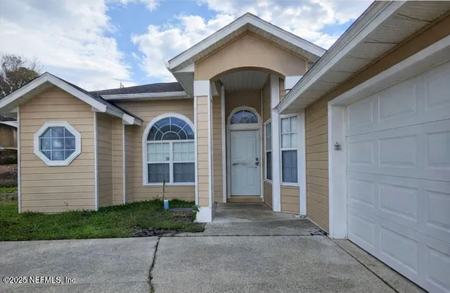 a view of an empty room and window and fire place