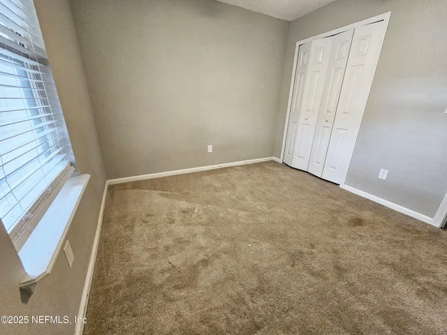 a view of a house with a garden and yard