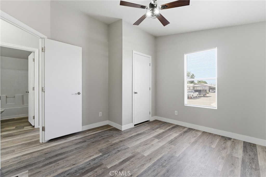 20843 Waalew Road, Unit C125 Apple Valley, CA 92307 - Photo 17 of 38 a view of an empty room with wooden floor and a window