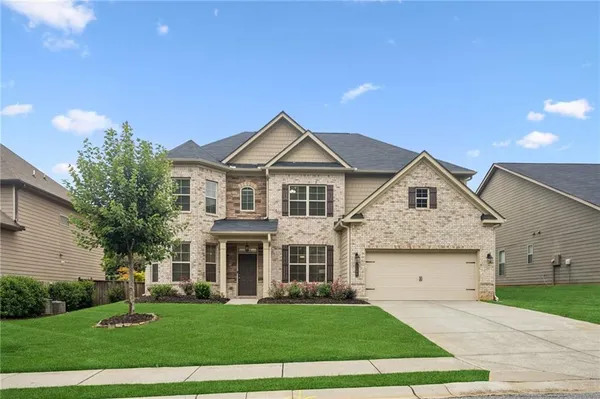 a front view of a house with a yard