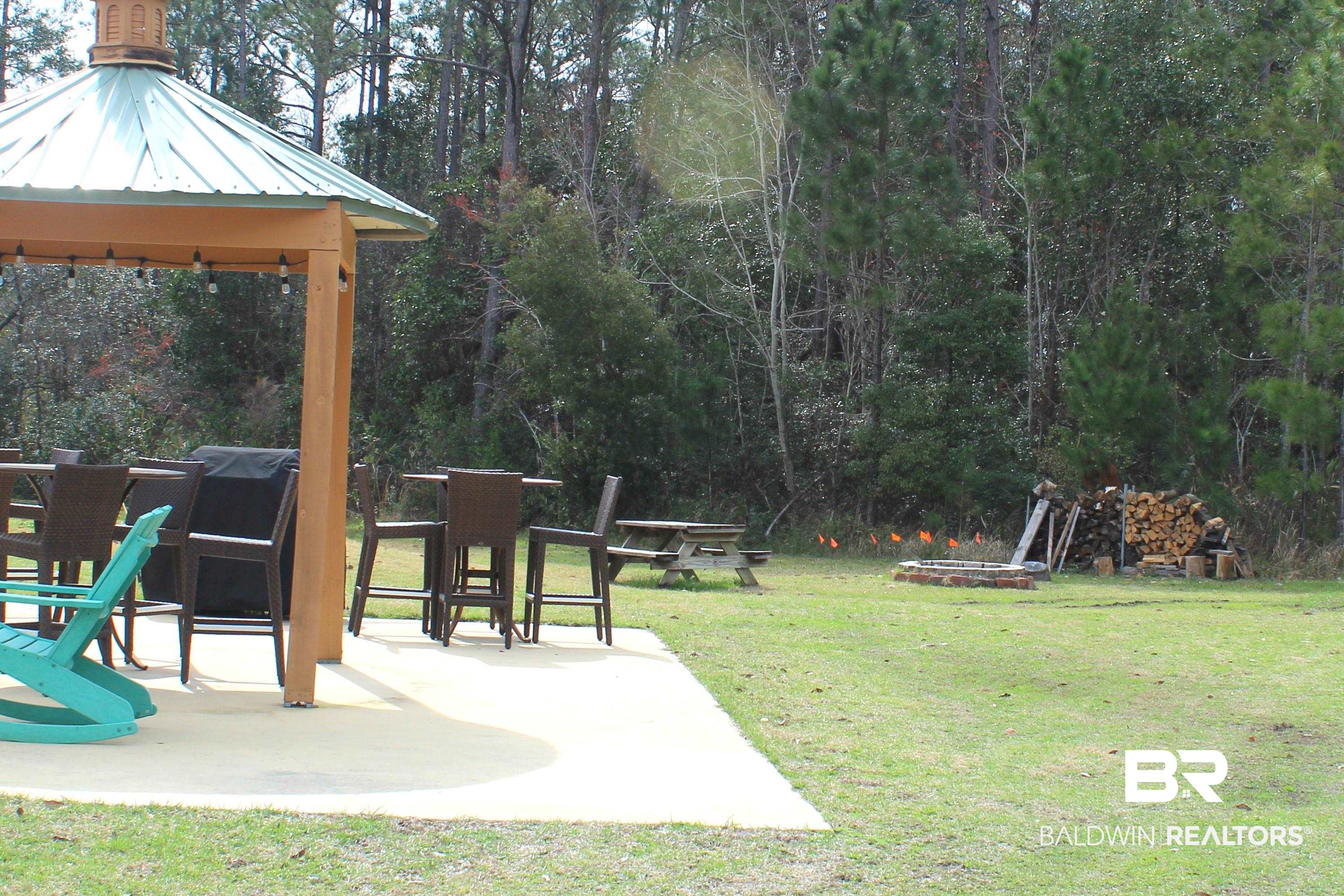 28121 Migratory Way Elberta, AL 36530 - Photo 47 of 51 View of yard with an outdoor fire pit and a gazebo