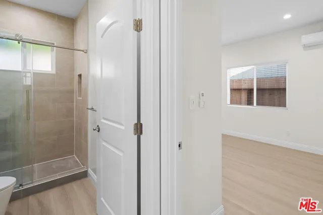 a bathroom with a shower and a toilet