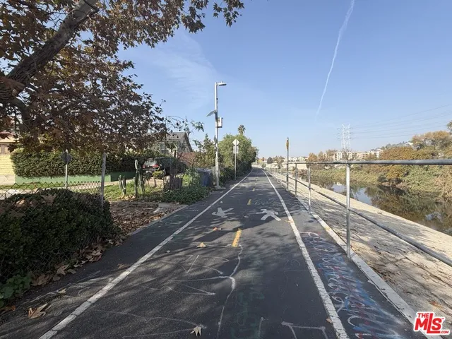 a view of a city street with a yard