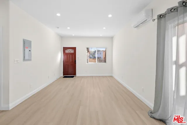 a view of an empty room and a window