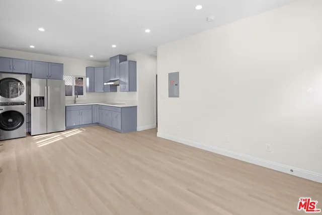 a view of kitchen and refrigerator sink