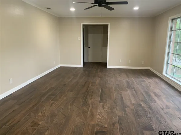wooden floor in an empty room with a window