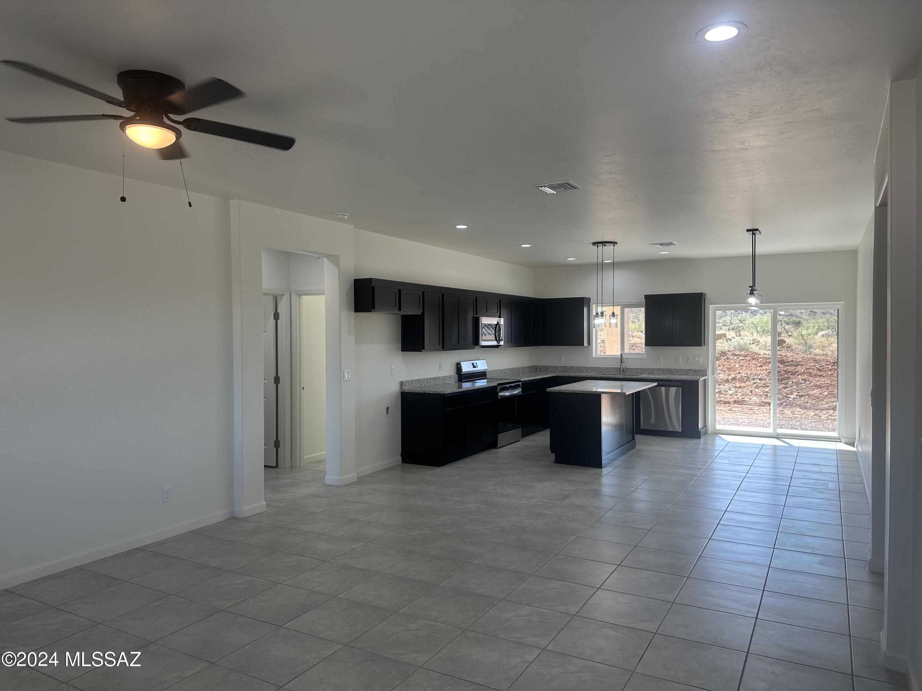 169 Camino Mar Rio Rico, AZ 85648 - Photo 9 of 40 a large white kitchen with a large counter top and outdoor space