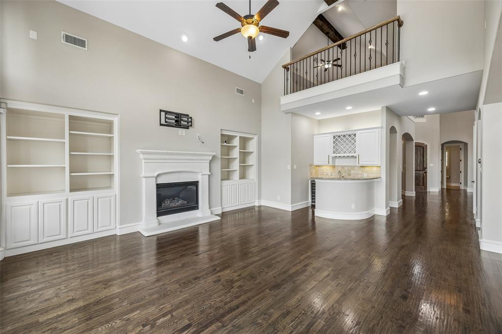 134 Santa Rosa Way Irving, TX 75062 - Photo 3 of 26 Open-concept living room with soaring ceilings, wood floors, and seamless flow to the bar and entertaining spaces