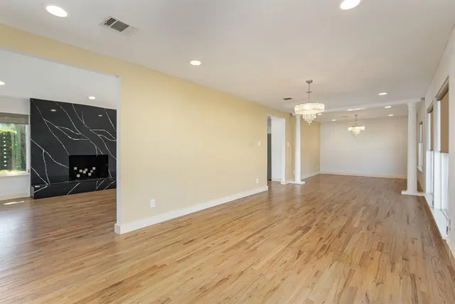 a view of a livingroom with a hall and wooden floor