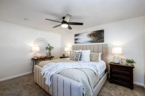 a bedroom with a bed and a chandelier