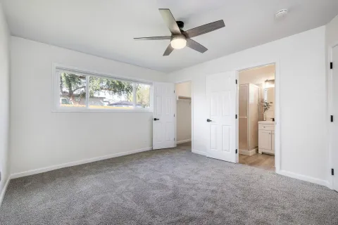 a view of bathroom with a toilet sink and mirror