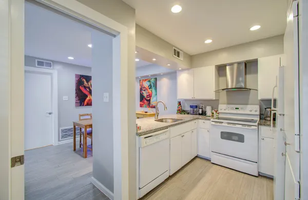 a kitchen with a sink cabinets and wooden floor
