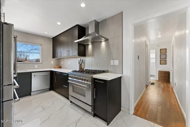 a kitchen with stainless steel appliances granite countertop a stove and a sink