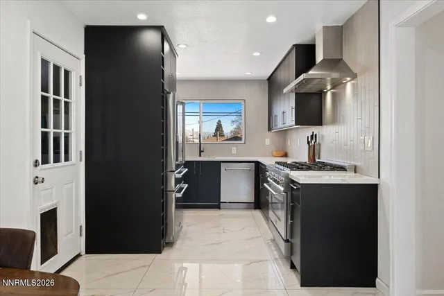 a large kitchen with stainless steel appliances granite countertop a stove and a sink