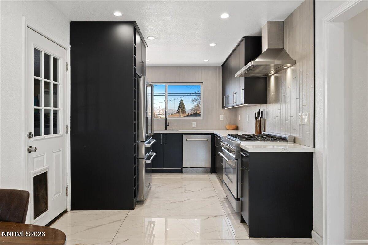 736 Yori Avenue Reno, NV 89502 - Photo 12 of 35 a large kitchen with stainless steel appliances granite countertop a stove and a sink