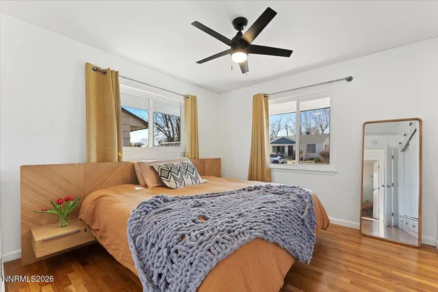 a bedroom with a bed and wooden floor