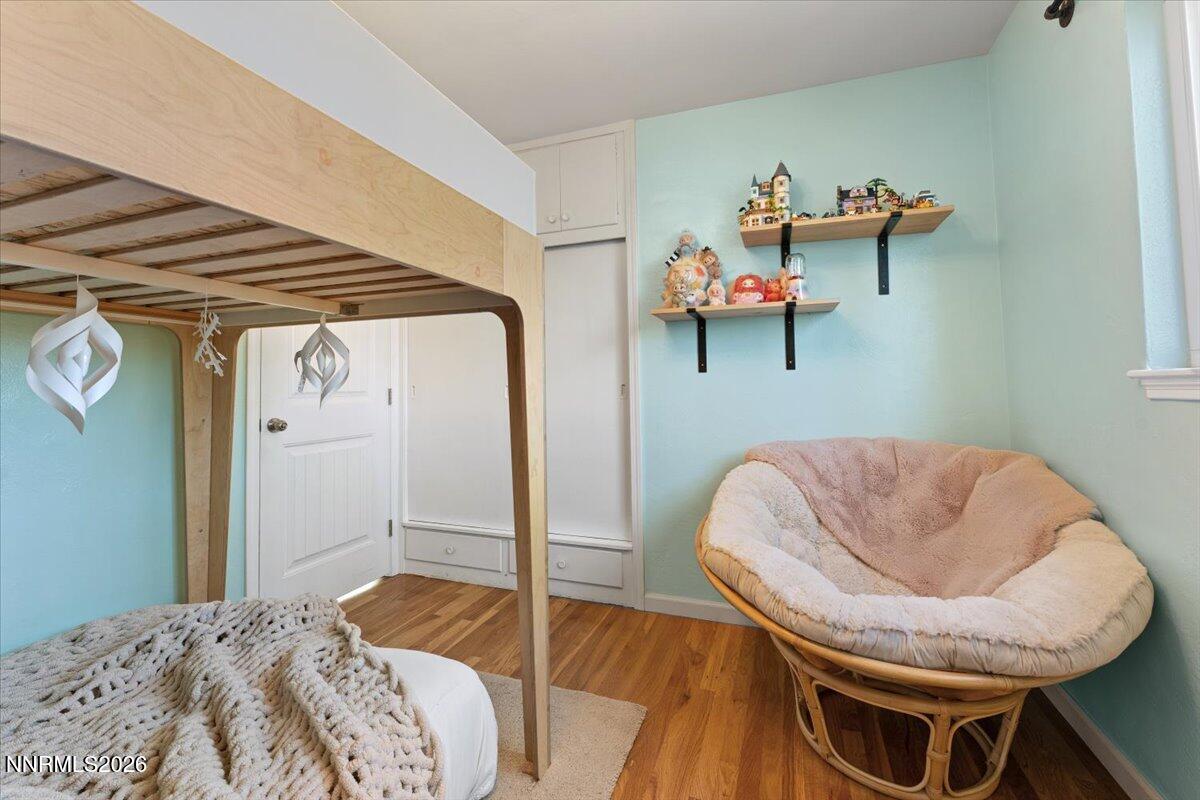 736 Yori Avenue Reno, NV 89502 - Photo 25 of 35 a bedroom with a bed and a chandelier