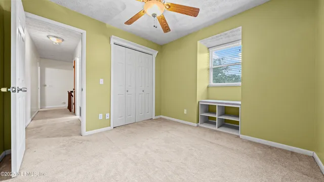 an empty room with a door and a bathroom