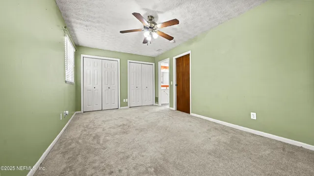 an empty room and a ceiling fan in it