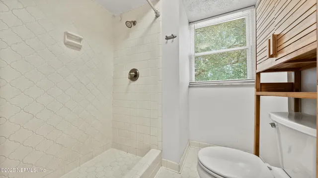 a white toilet sitting next to a bathroom sink
