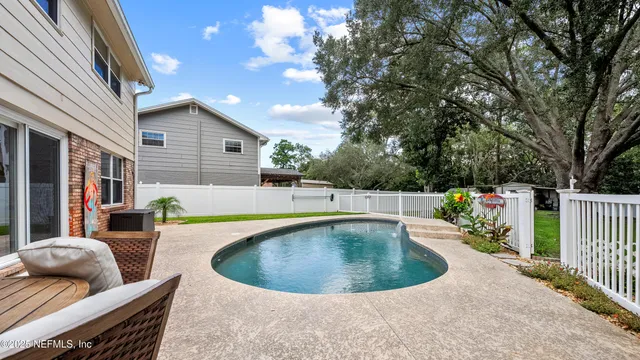 a view of a house with swimming pool and sitting area