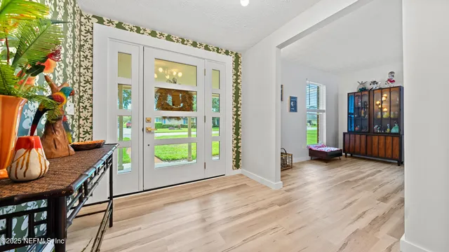 a view of an entryway with wooden floor and door