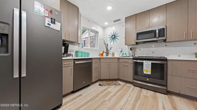 a kitchen with a sink stove and microwave