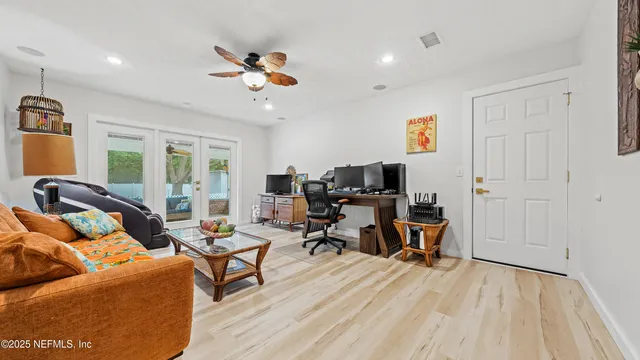 a view of a livingroom with workspace and a couch