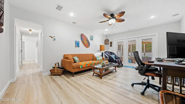 a living room with furniture gym equipment and a ceiling fan