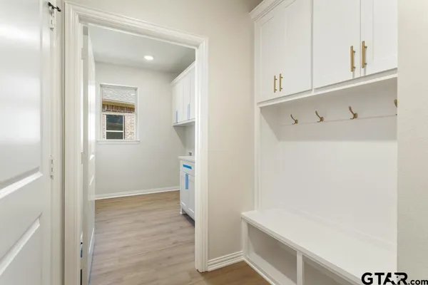 a view of storage and utility room with wooden floor