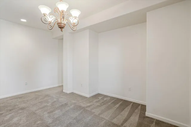 a view of a dining room with furniture wooden floor and chandelier