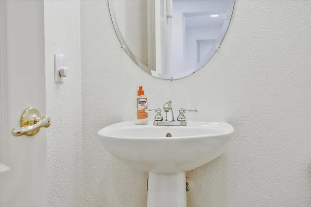a view of an empty room with a chandelier fan
