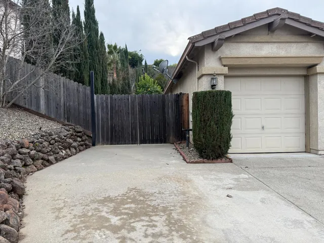a view of a house with wooden fence