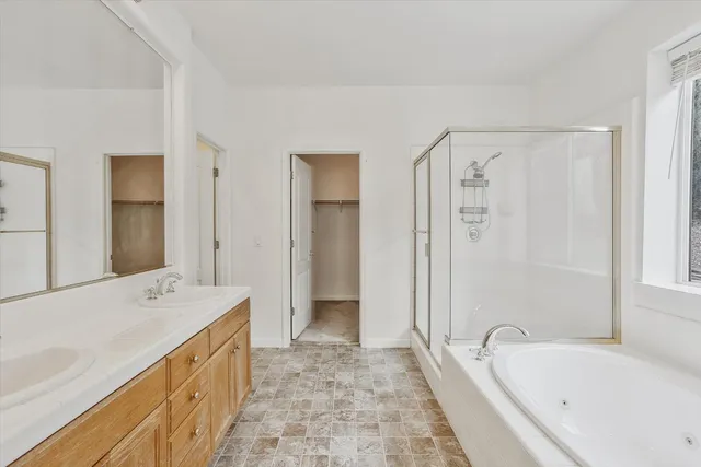 a bathroom with a tub sink and mirror