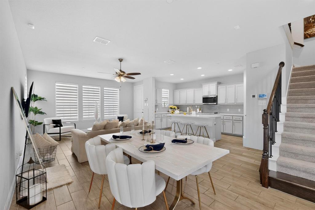 6040 Bursey Road Watauga, TX 76148 - Photo 12 of 39 Open concept living area featuring wood-look tile flooring, a dining area, and a kitchen with an island