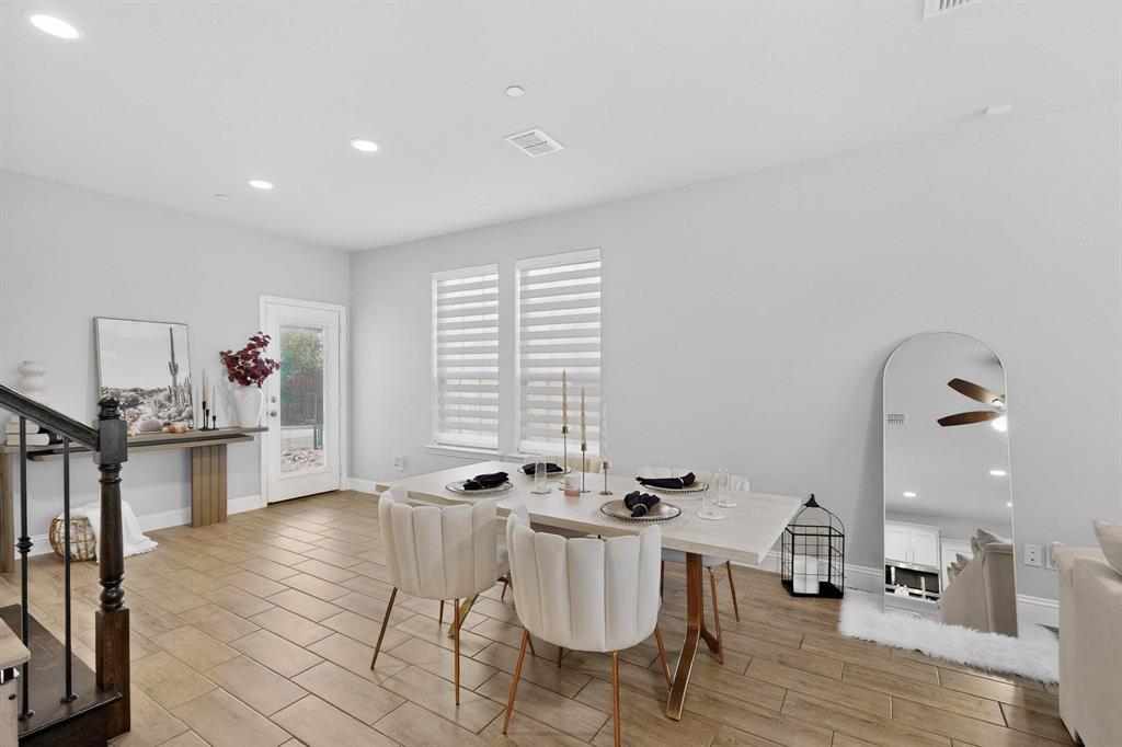 6040 Bursey Road Watauga, TX 76148 - Photo 13 of 39 The property features an open-concept dining area with large windows providing natural light, recessed lighting, and tile flooring