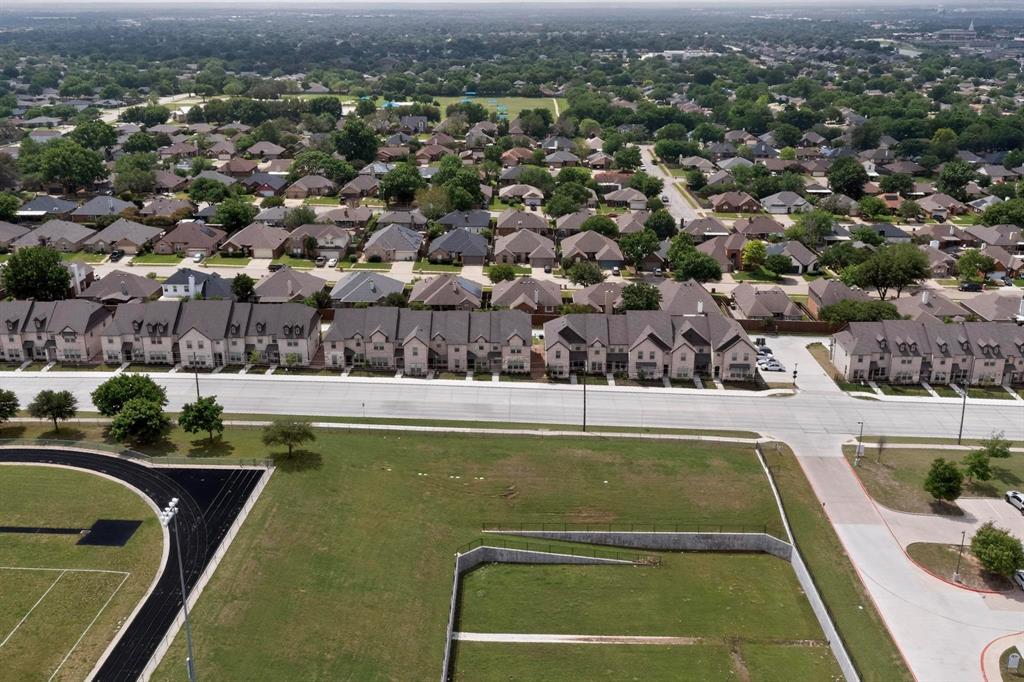 6040 Bursey Road Watauga, TX 76148 - Photo 3 of 39 Aerial view showcasing a community with residential properties, green spaces, and paved roads