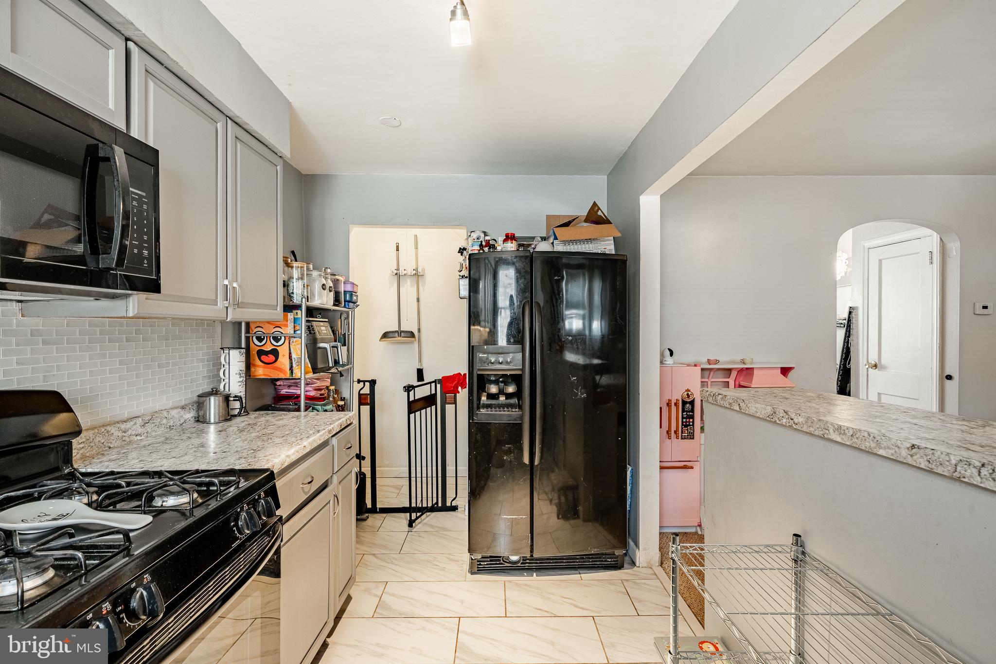 211 Wingate Road Upper Darby, PA 19082 - Photo 12 of 27 a kitchen with a stove and a refrigerator