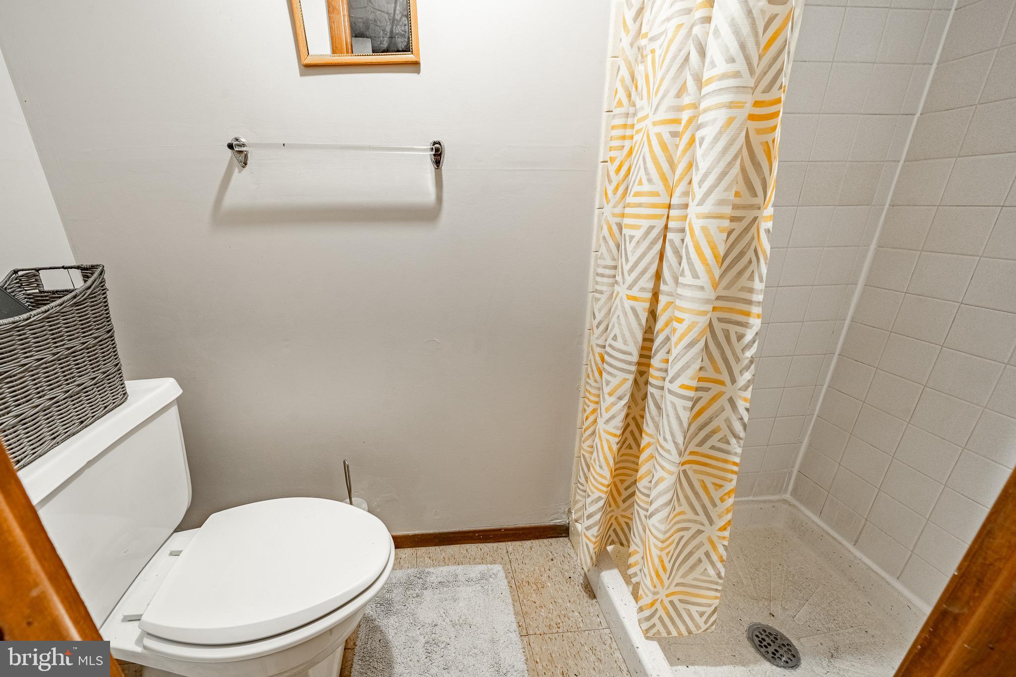 211 Wingate Road Upper Darby, PA 19082 - Photo 24 of 27 a white toilet sitting next to a shower curtain