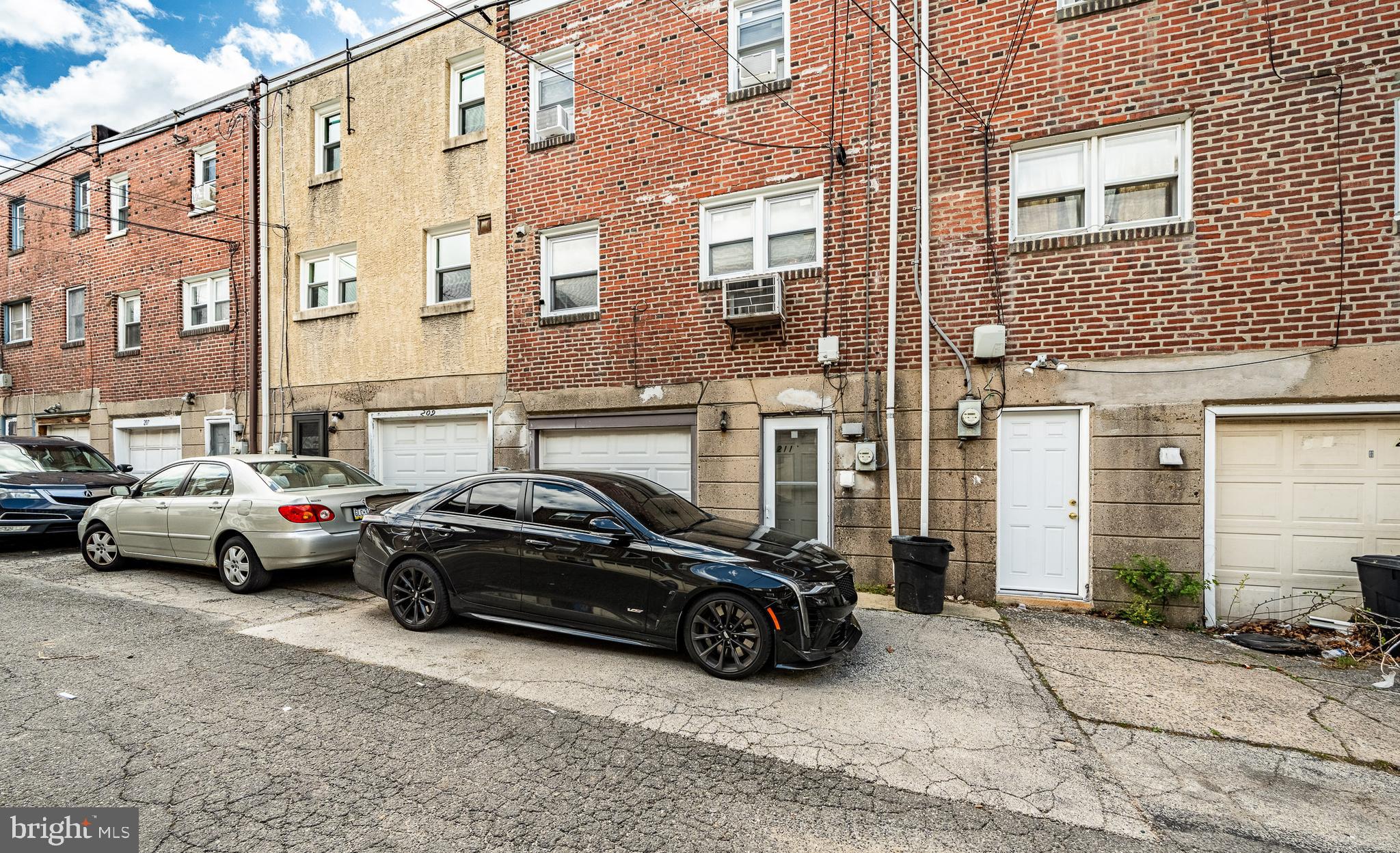 211 Wingate Road Upper Darby, PA 19082 - Photo 26 of 27 a view of cars parked in front of a brick building