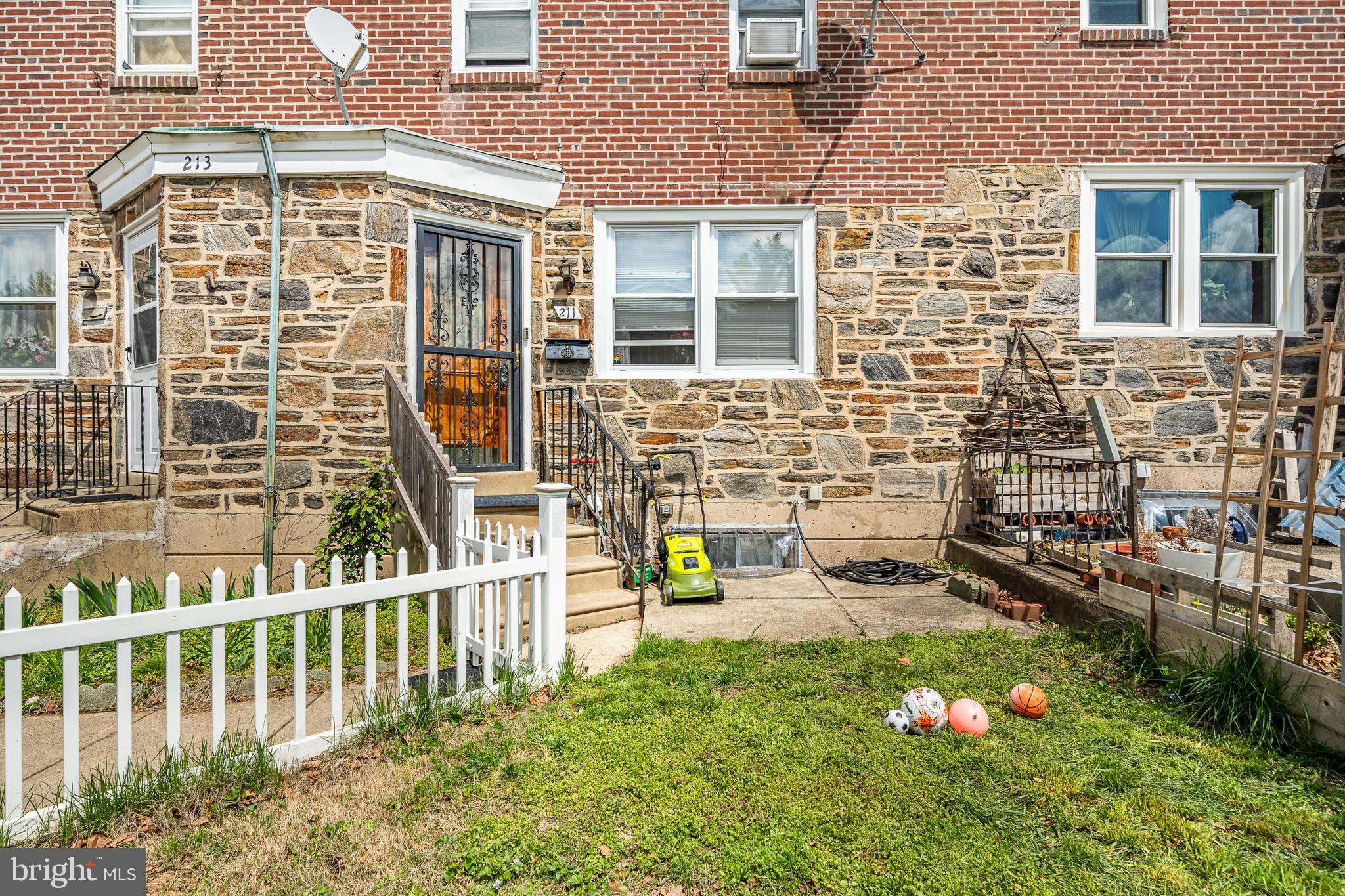 211 Wingate Road Upper Darby, PA 19082 - Photo 3 of 27 front view of a brick house with a yard