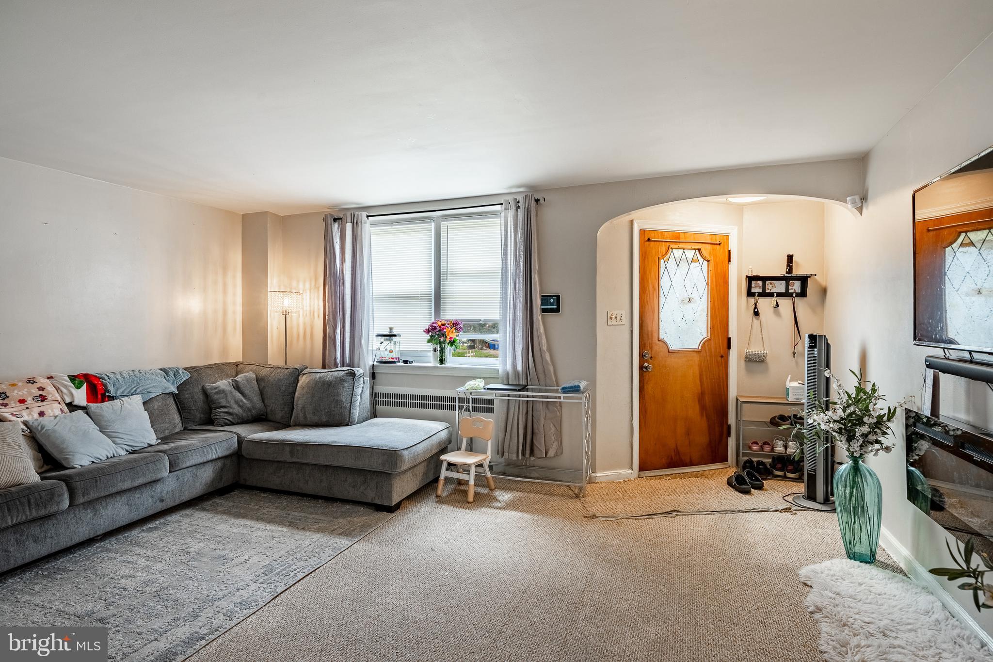 211 Wingate Road Upper Darby, PA 19082 - Photo 5 of 27 a living room with furniture and a flat screen tv