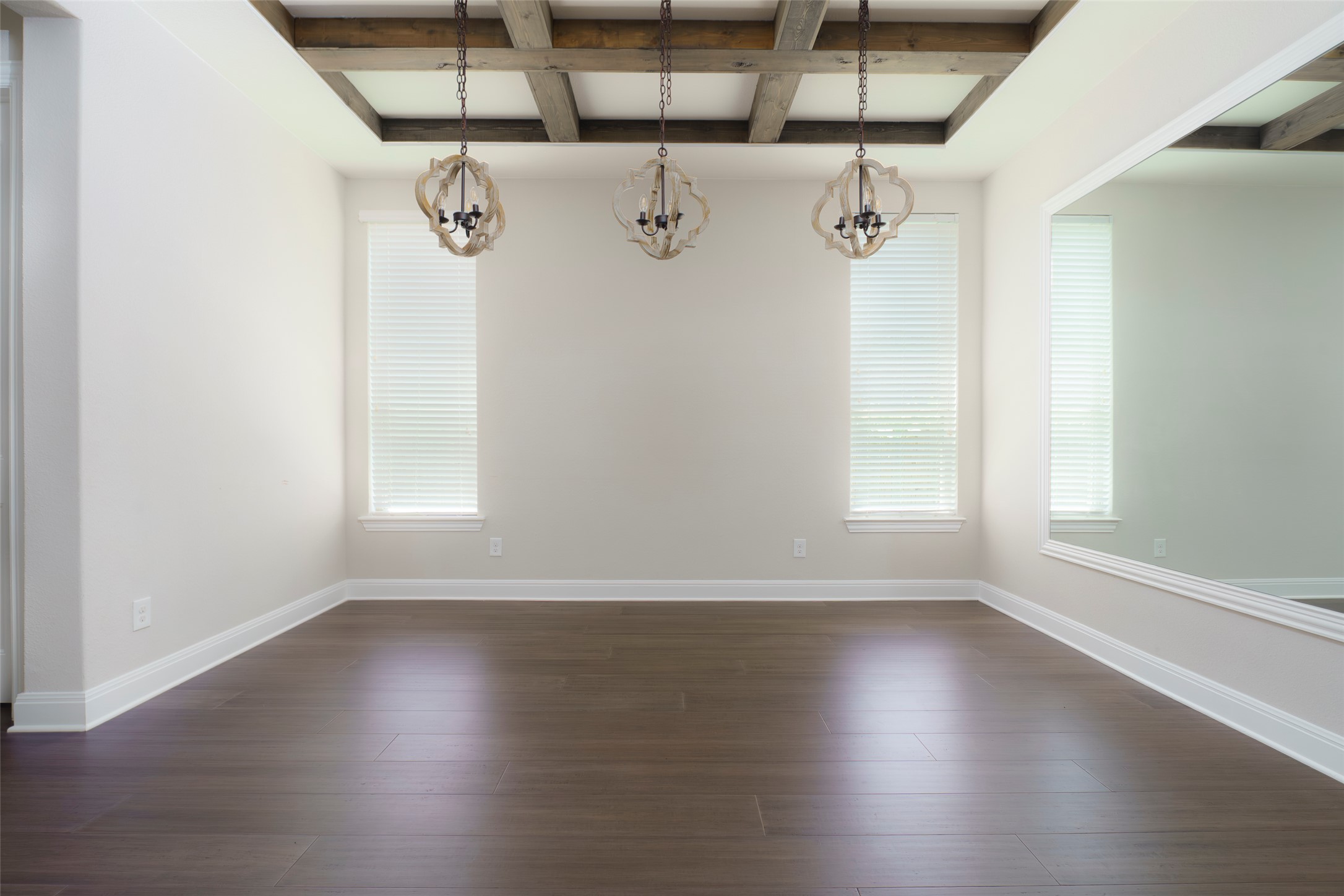 2305 Millbrook Loop Leander, TX 78641 - Photo 13 of 26 Hardwood floors and a beamed ceiling grace this versatile, naturally illuminated room.