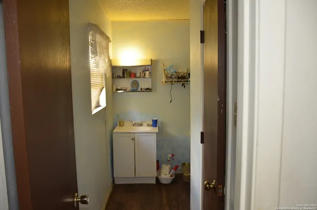 a bathroom with a sink and mirror with toilet
