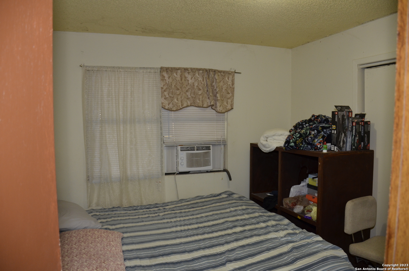10805 Hollowell Road Atascosa, TX 78002 - Photo 16 of 25 a bedroom with a bed and a mirror