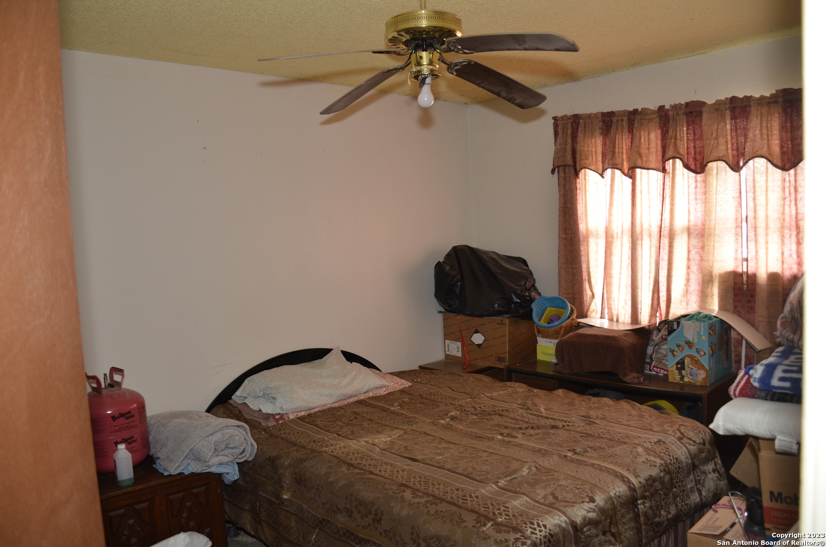10805 Hollowell Road Atascosa, TX 78002 - Photo 17 of 25 a bedroom with a bed and a chandelier